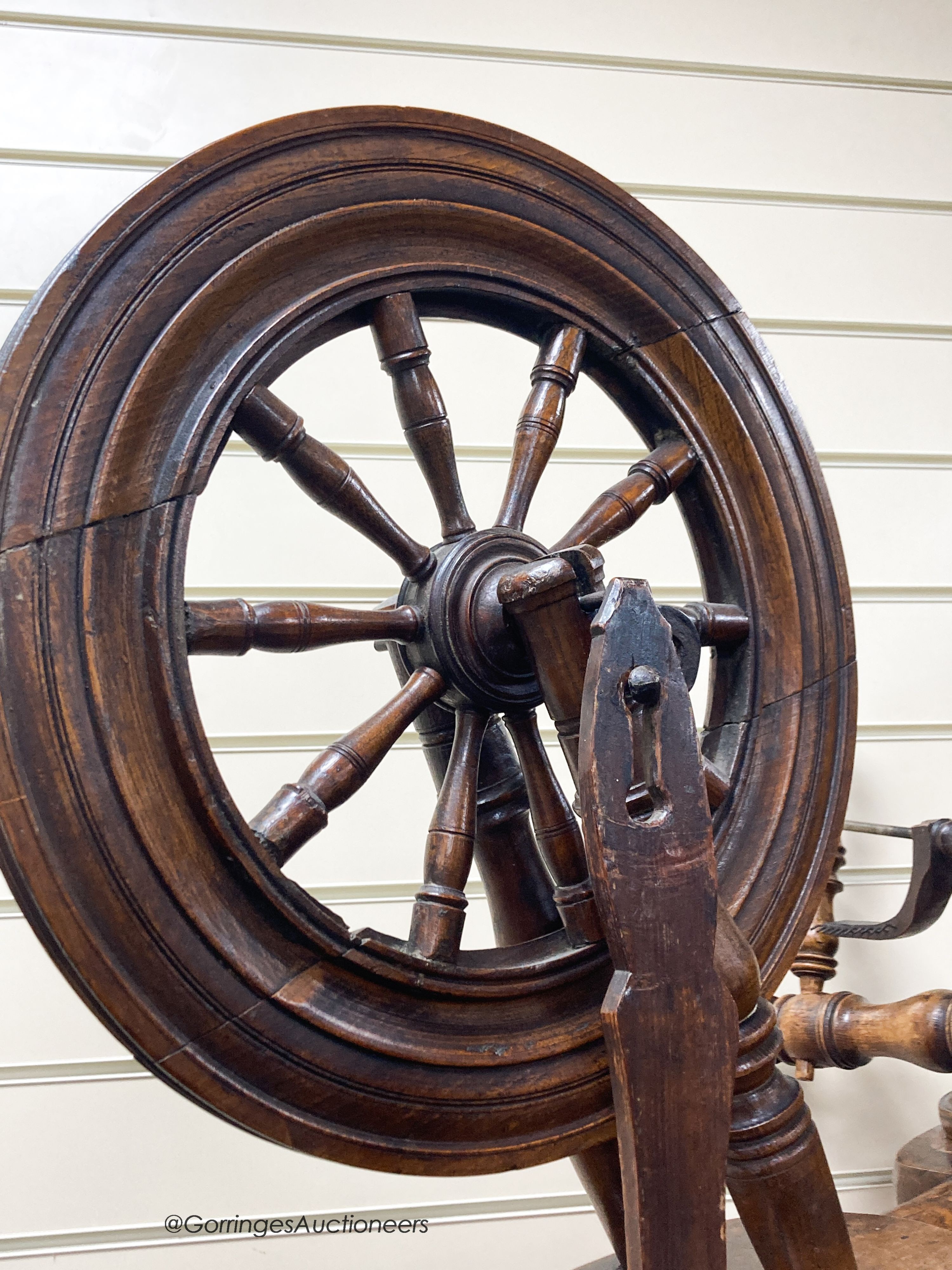 A 19th century beech and elm spinning wheel, height 92cm